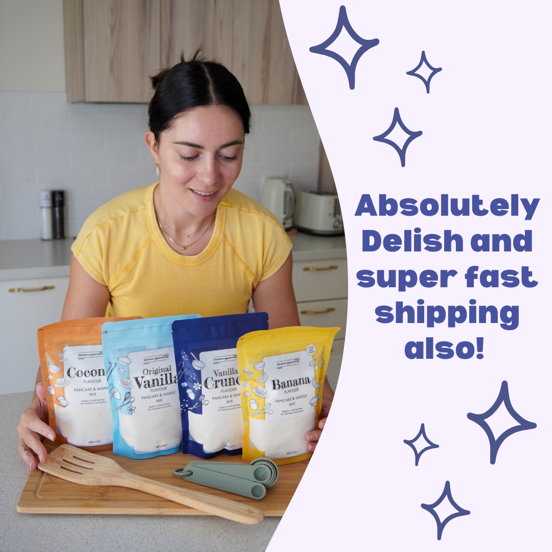 Woman holding packages of different flavored pancake mixes in a kitchen setting